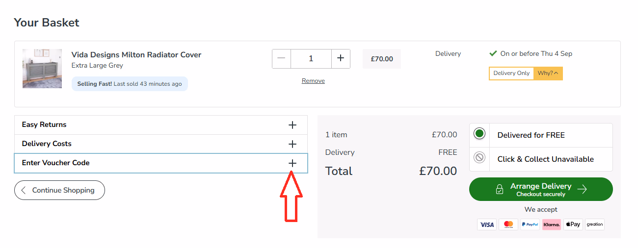Dunelm basket page showing where to click “Enter Voucher Code” with a red arrow pointing to the plus icon.